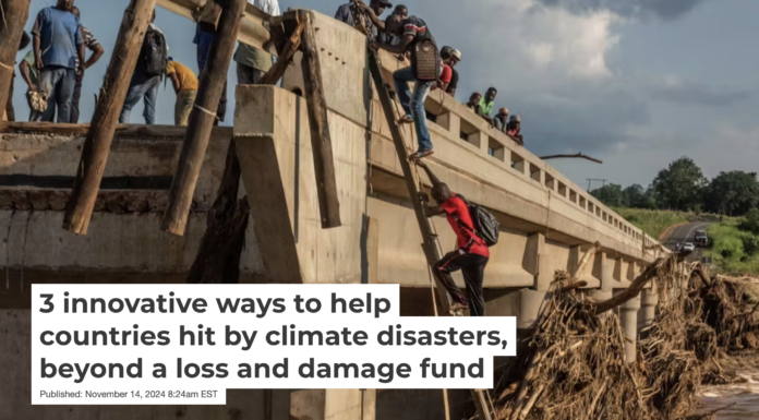 People climb to the top of a bridge damaged when Cyclone Idai hit Mozambique in 2019. Andrew Renneisen/Getty Images